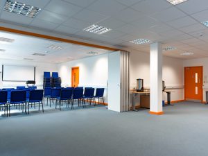 Office Q with four rows of chairs - the rest of the room is empty floor space.